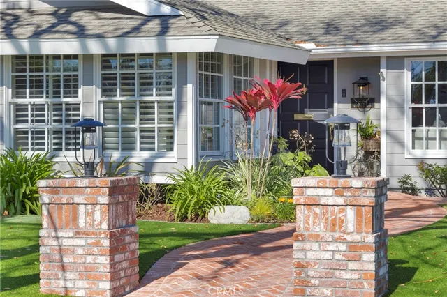 a front view of house with a garden