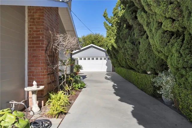 a pathway of a house with a yard