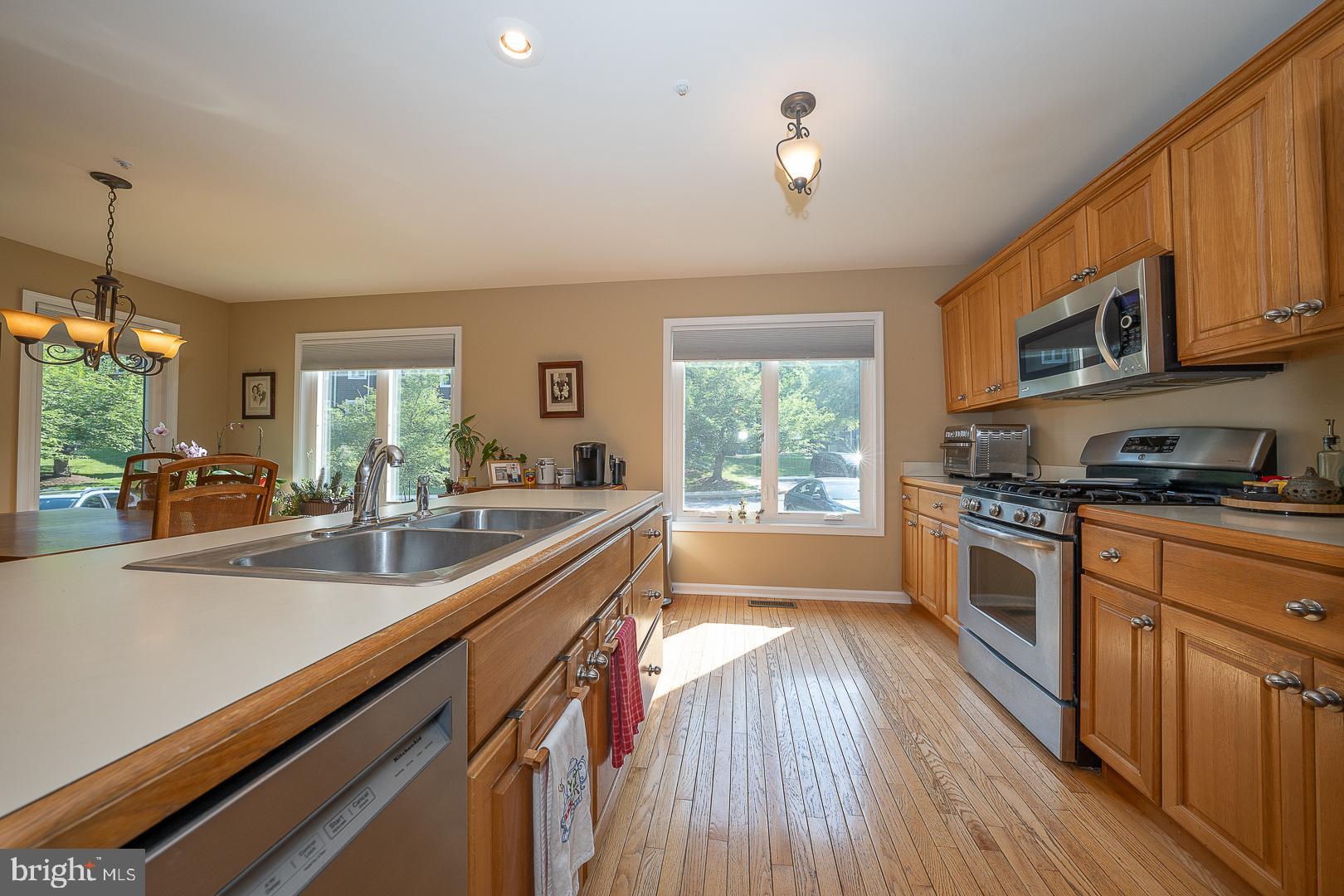 224 Fox Run Exton, PA 19341 - Photo 11 of 40 a large kitchen with stainless steel appliances granite countertop a lot of counter space and wooden floors