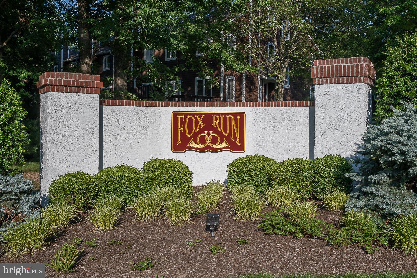 224 Fox Run Exton, PA 19341 - Photo 2 of 40 a sign that is sitting in front of flowers