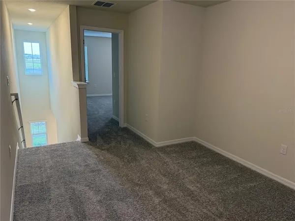 an empty room that has a mirror