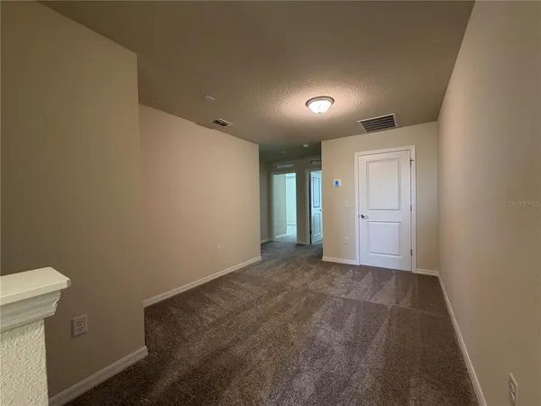 an empty room with closet area