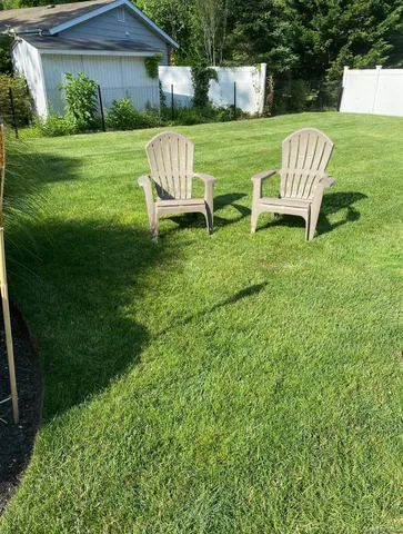 a yard with lots of green space and a lake view