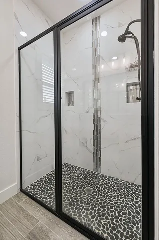 a bathroom with a glass shower door