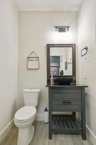 a bathroom with a toilet a sink and mirror