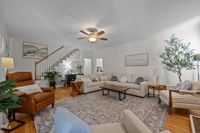 a living room with furniture a chandelier and a fireplace