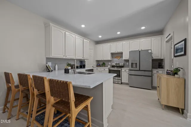 a living room with furniture potted plant and a window