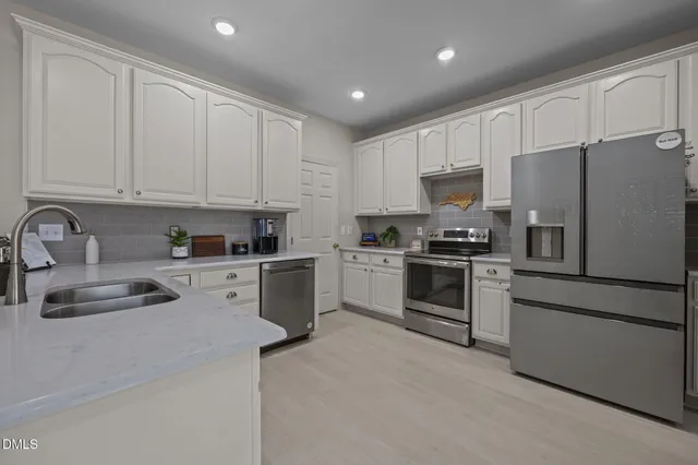 a kitchen with kitchen island granite countertop wooden cabinets and stainless steel appliances