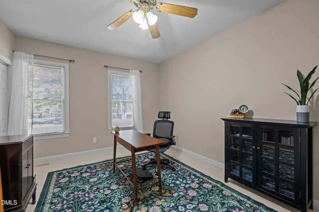 a view of a patio with table and chairs under an umbrella with wooden floor