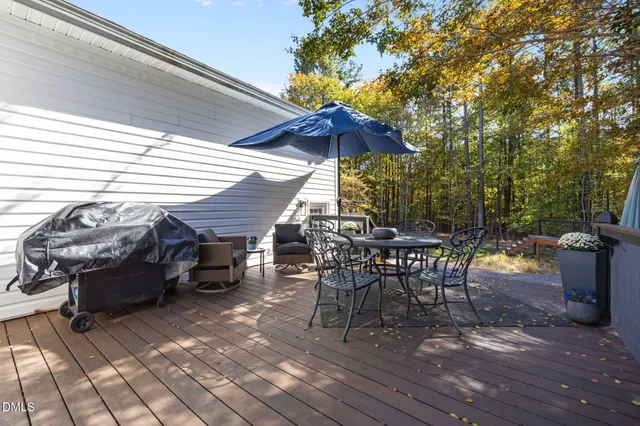 a view of a house with yard and sitting area