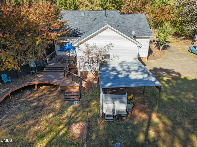 a backyard of a house with table and chairs