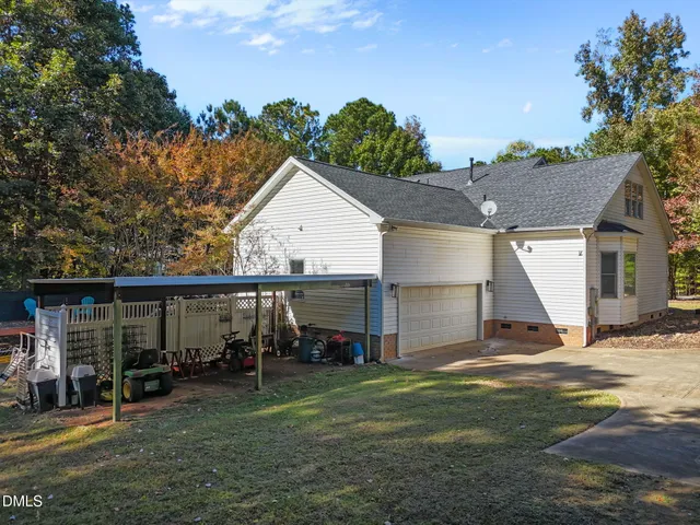 an aerial view of residential houses with outdoor space and trees