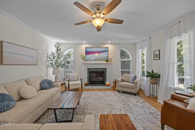 a living room with furniture a fireplace and a flat screen tv