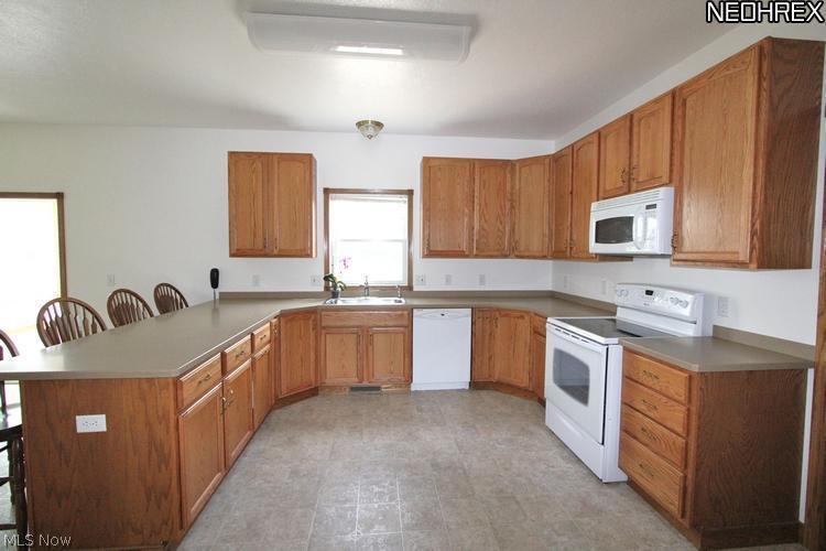 6242 Streeter Road Mantua, OH 44255 - Photo 8 of 24 Kraftmaid cabinetry, solid surface countertops, extended bar area. Includes appliances.