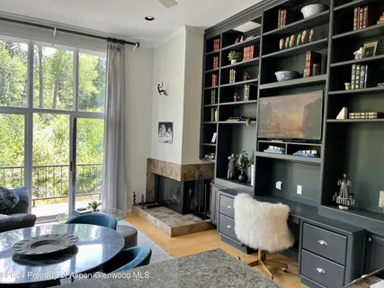 a living room with furniture potted plant and a large window