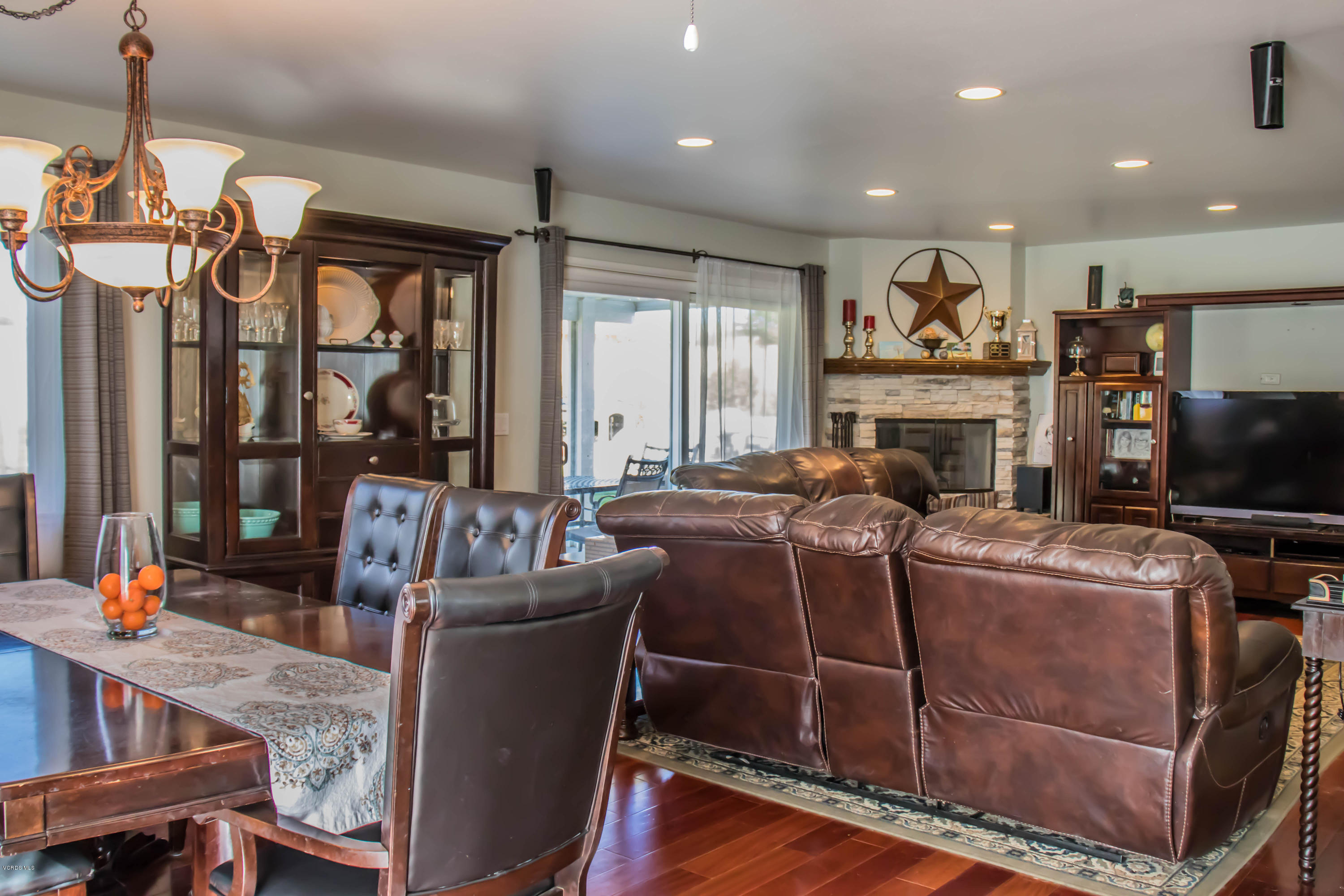 648 Appleton Road Simi Valley, CA 93065 - Photo 12 of 42 a living room with furniture a flat screen tv and a floor to ceiling window