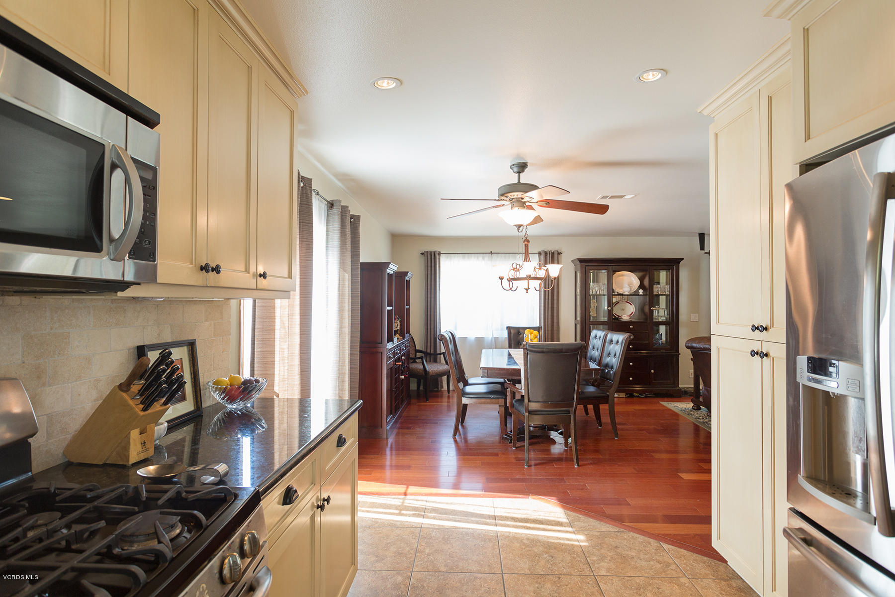 648 Appleton Road Simi Valley, CA 93065 - Photo 18 of 42 a kitchen with stainless steel appliances a dining table chairs stove refrigerator and cabinets