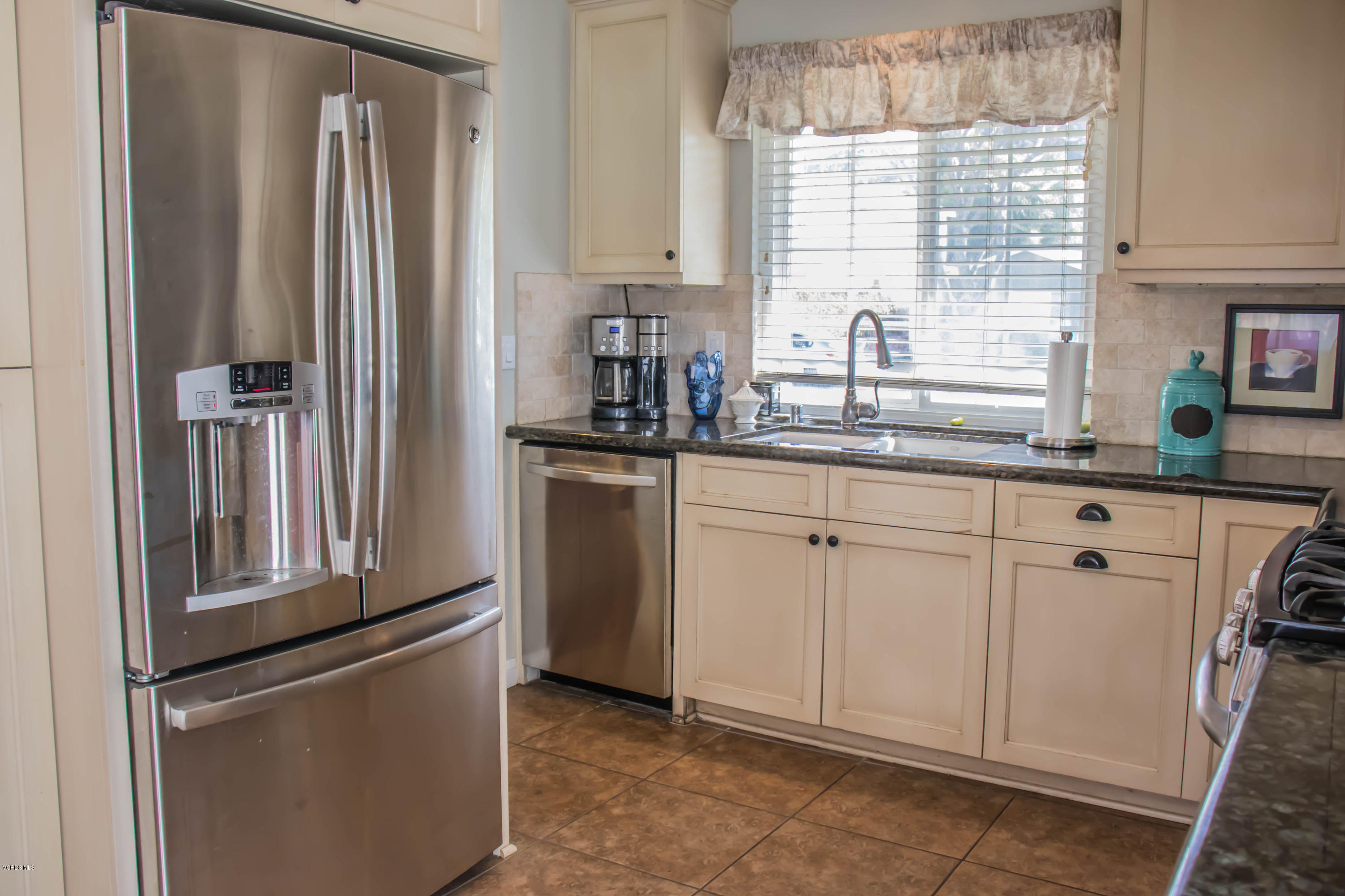 648 Appleton Road Simi Valley, CA 93065 - Photo 24 of 42 a kitchen with white cabinets and white appliances