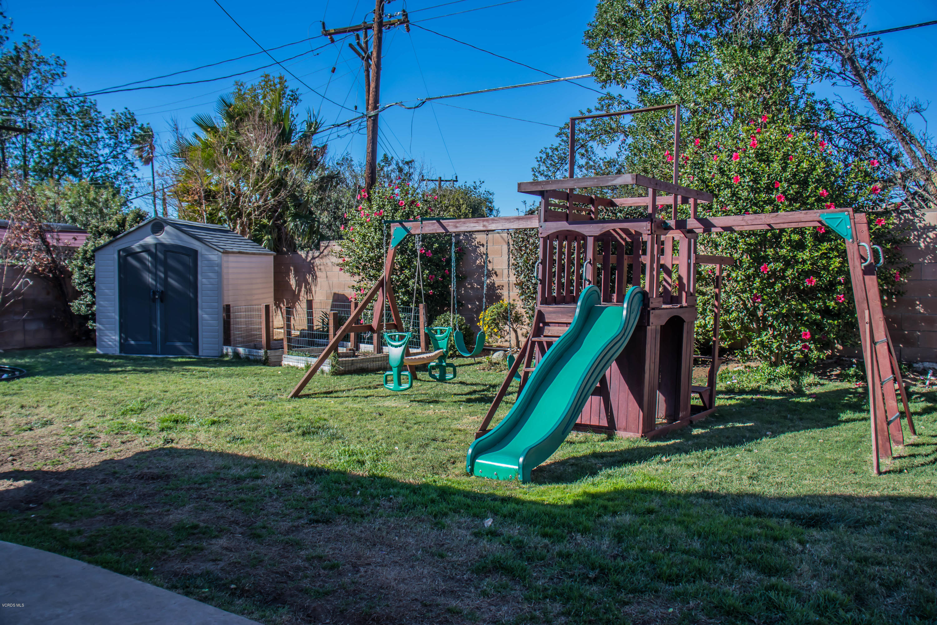 648 Appleton Road Simi Valley, CA 93065 - Photo 39 of 42 a view of a backyard with a slide trees and wooden fence