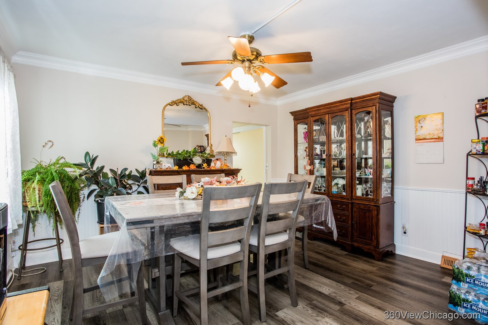 6308 Main Street Union, IL 60180 - Photo 8 of 39 a dining room with furniture potted plants and a chandelier