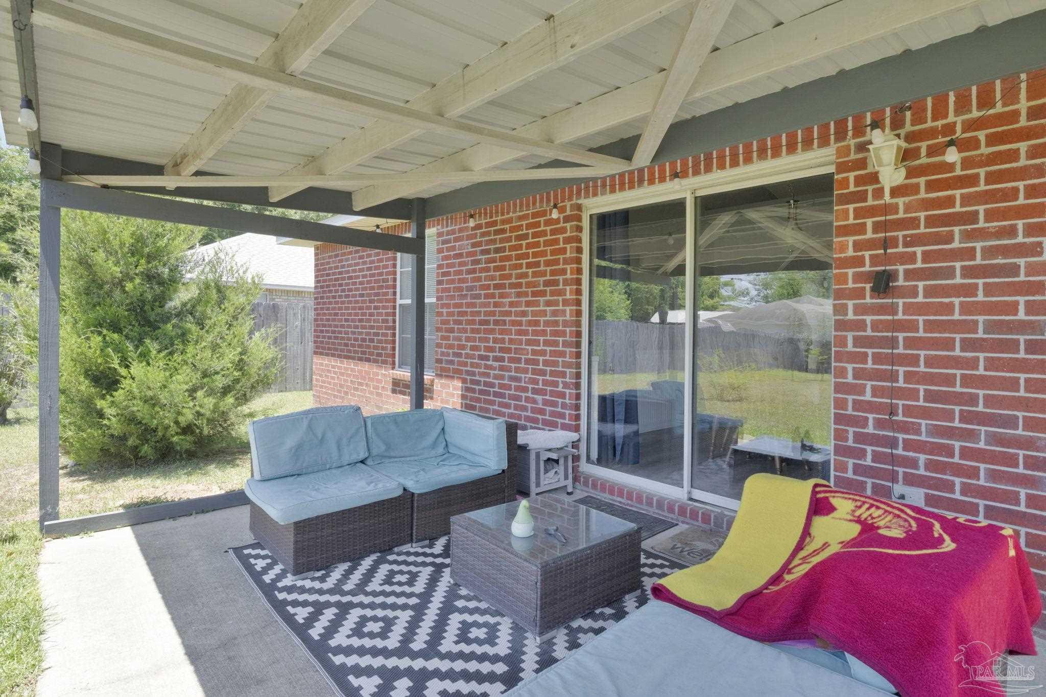 5539 Windrun Place Pace, FL 32571 - Photo 6 of 62 a outdoor space with patio the couches and a dining table with the garden view