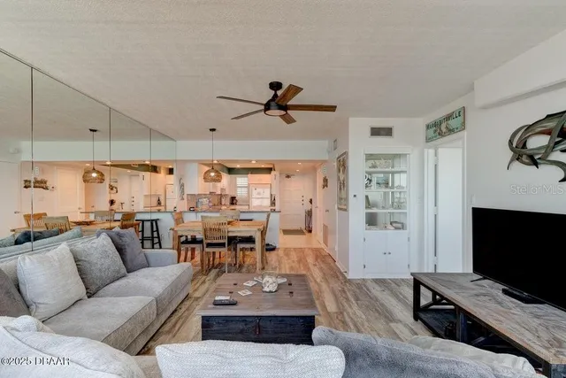 a living room with lots of furniture and a large window