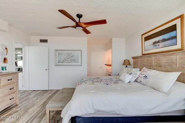 a spacious bedroom with a large bed and a large window