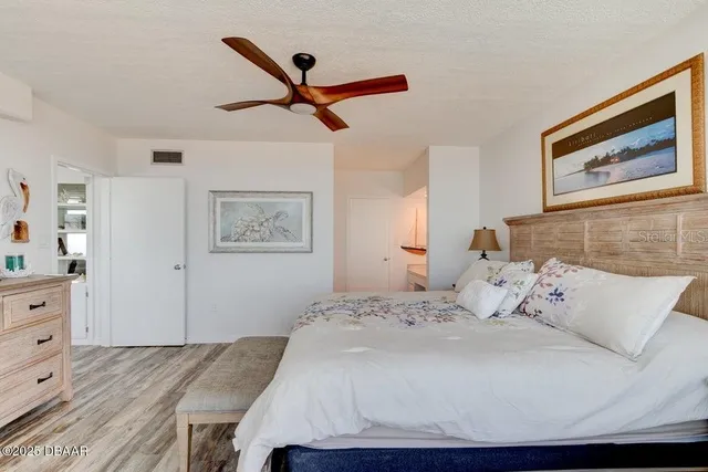 a spacious bedroom with a large bed and a large window