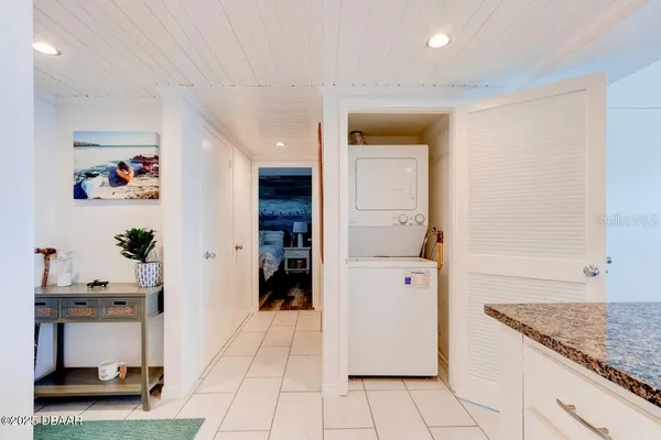 a kitchen with stainless steel appliances kitchen island granite countertop a refrigerator and a sink