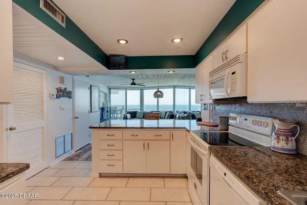 a kitchen with a sink window and cabinets