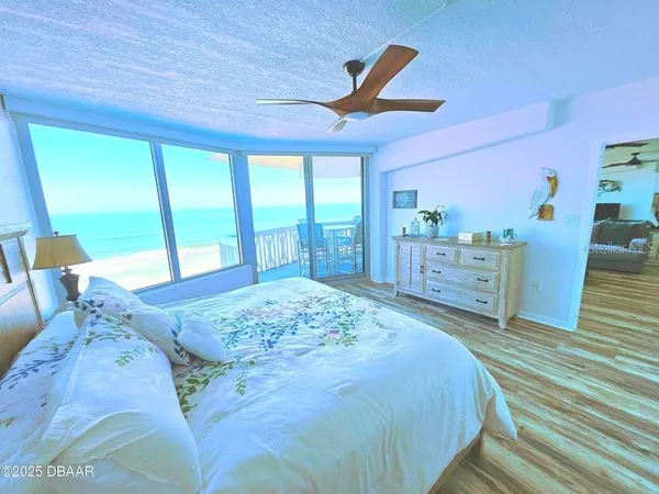 a spacious bedroom with a large bed and a large window