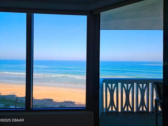 a living room with furniture a flat screen tv and a large window
