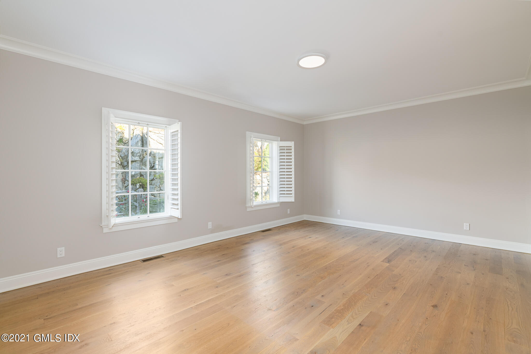 550 River Road Cos Cob, CT 06807 - Photo 12 of 33 an empty room with wooden floor and windows