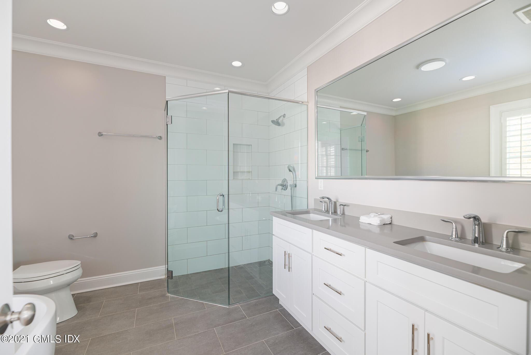 550 River Road Cos Cob, CT 06807 - Photo 16 of 33 a spacious bathroom with a shower sink mirror and toilet