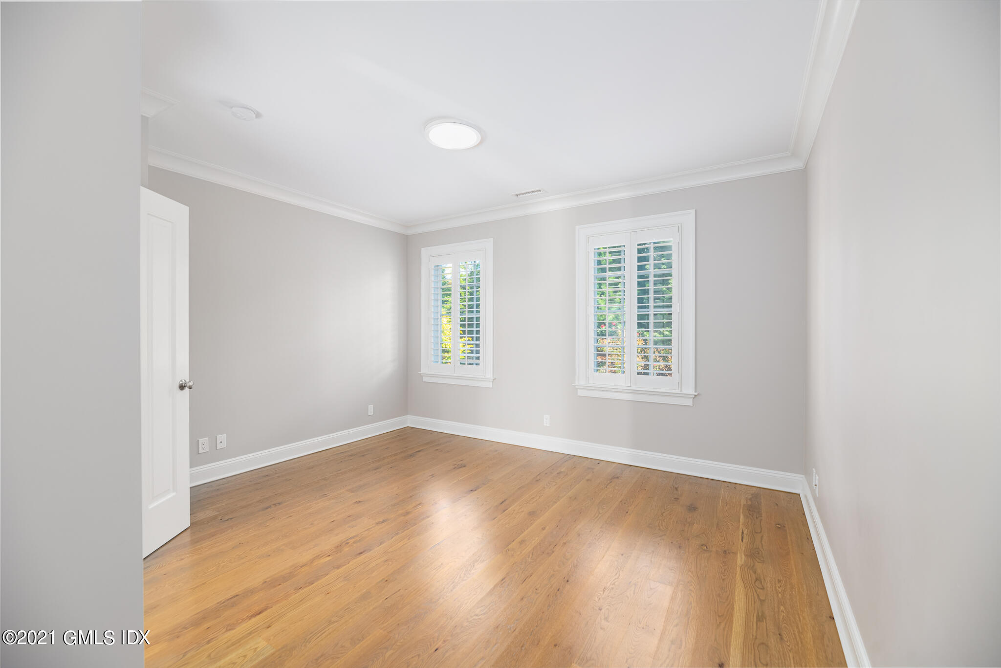 550 River Road Cos Cob, CT 06807 - Photo 17 of 33 a view of an empty room with wooden floor and a window