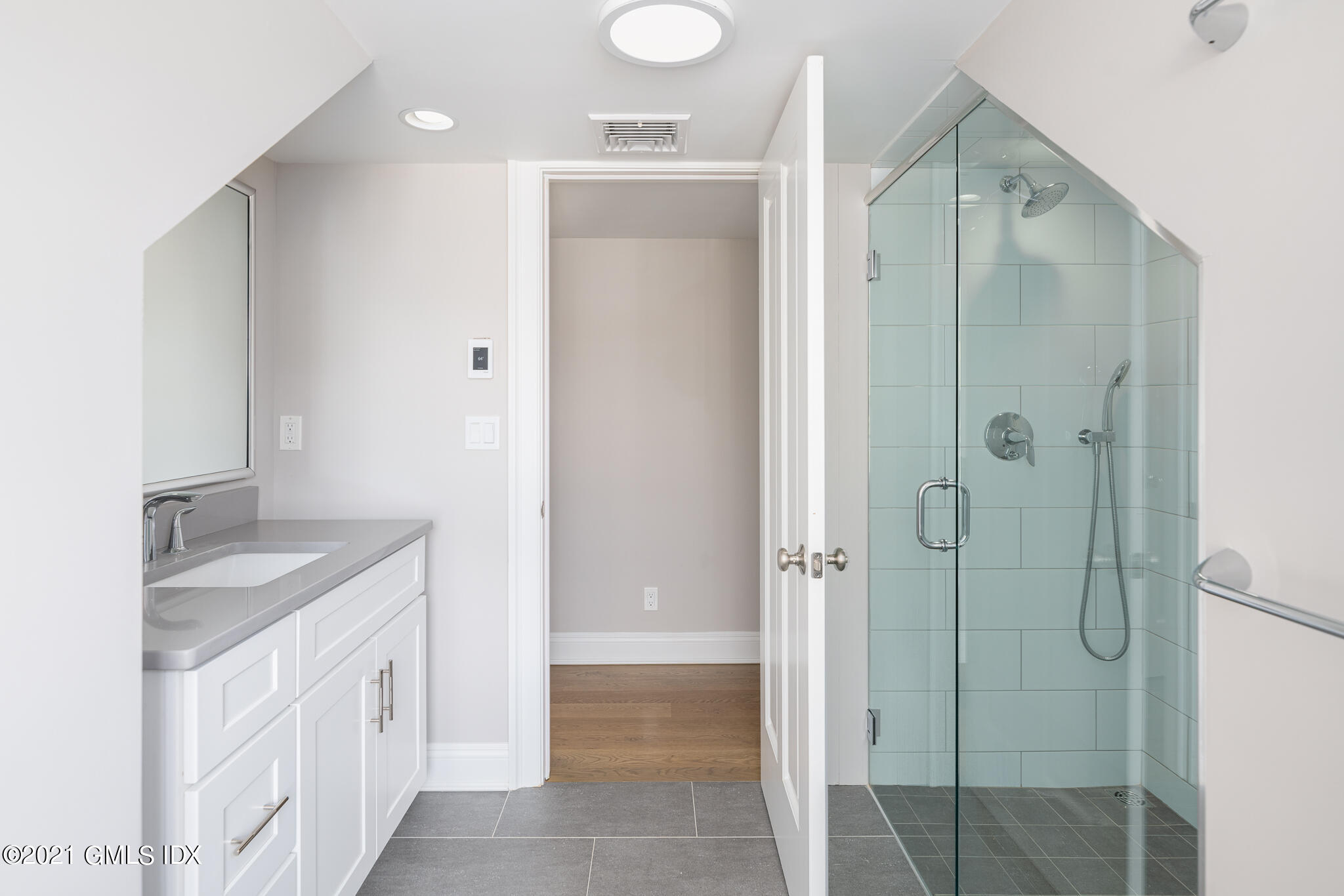 550 River Road Cos Cob, CT 06807 - Photo 23 of 33 a bathroom with a granite countertop sink mirror and shower