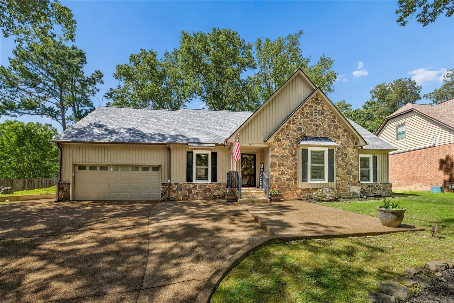 8970 Farmoor Road Germantown, TN 38139 - Photo 2 of 35 Stone and siding exterior with a pitched roofline