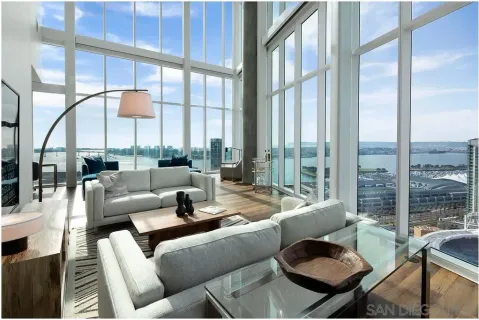a living room with furniture city view and large windows
