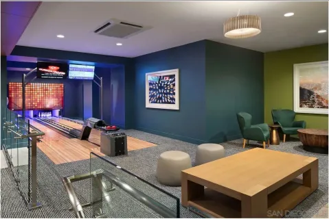 a room with furniture pool table and window