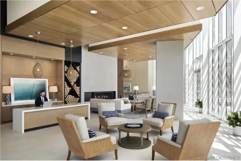 a living room with couches and a view of kitchen with wooden floor