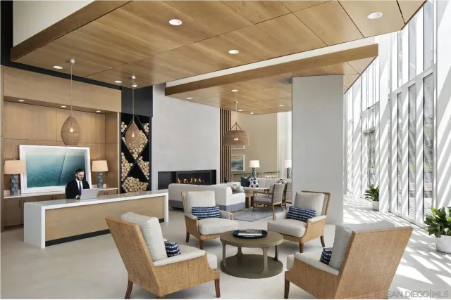 a living room with couches and a view of kitchen with wooden floor