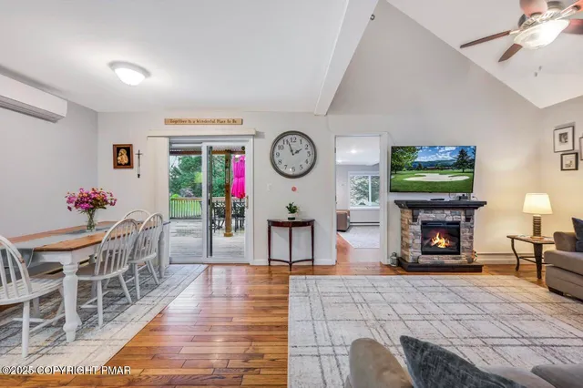 a living room with furniture a fireplace and a flat screen tv