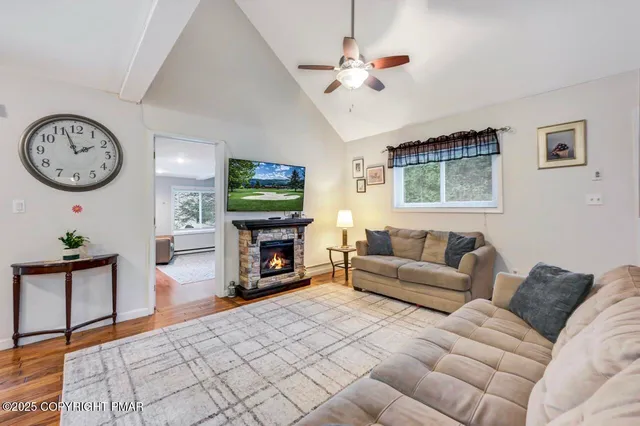 a living room with furniture a fireplace and a flat screen tv