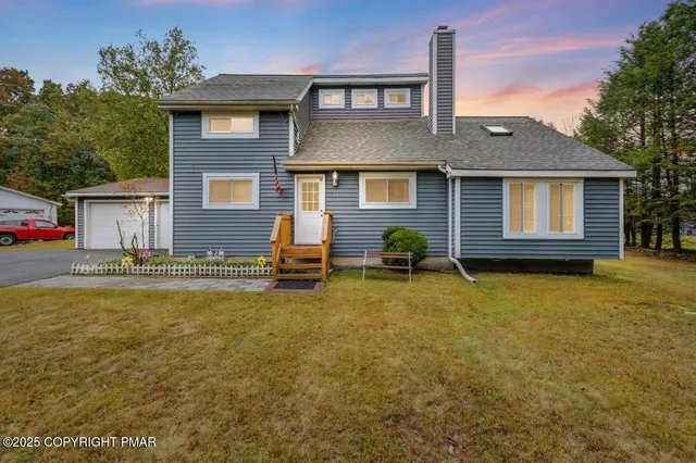 a front view of house with yard outdoor seating and barbeque oven