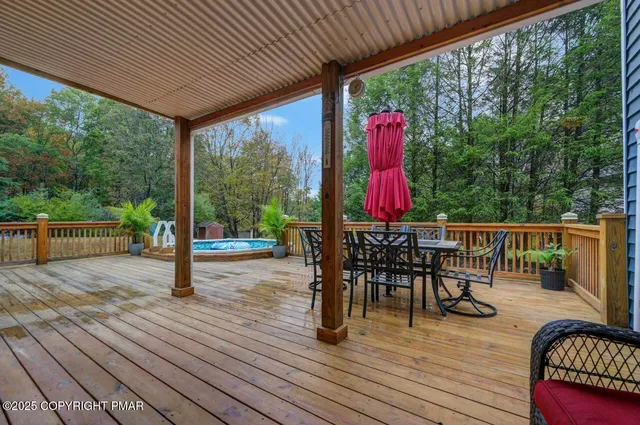 a view of a chairs and table in patio with wooden floor