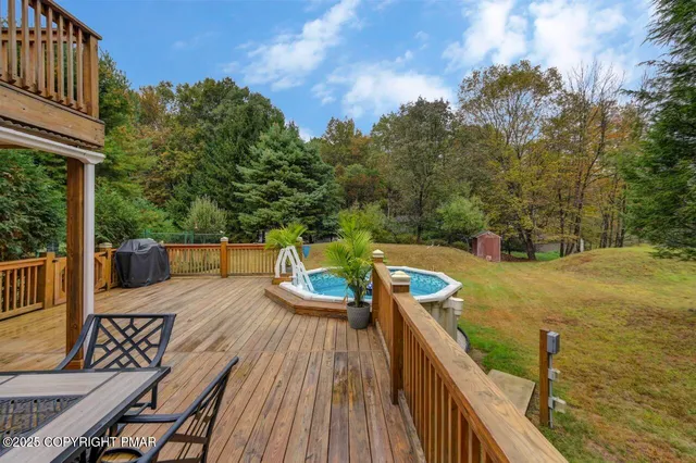 a view of deck with furniture and trees