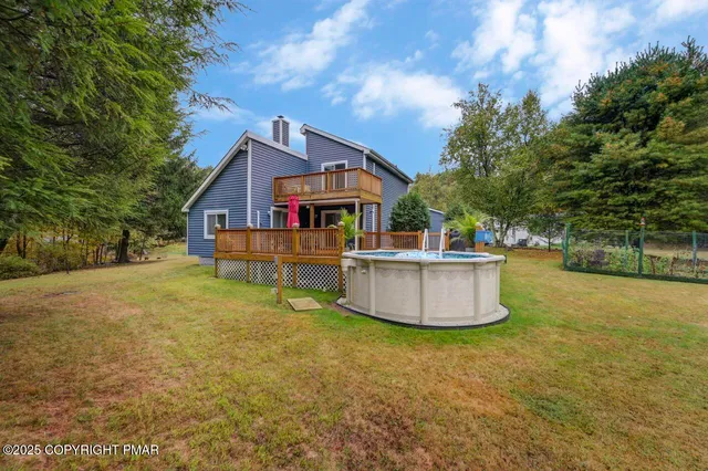 a view of a house with pool and chairs