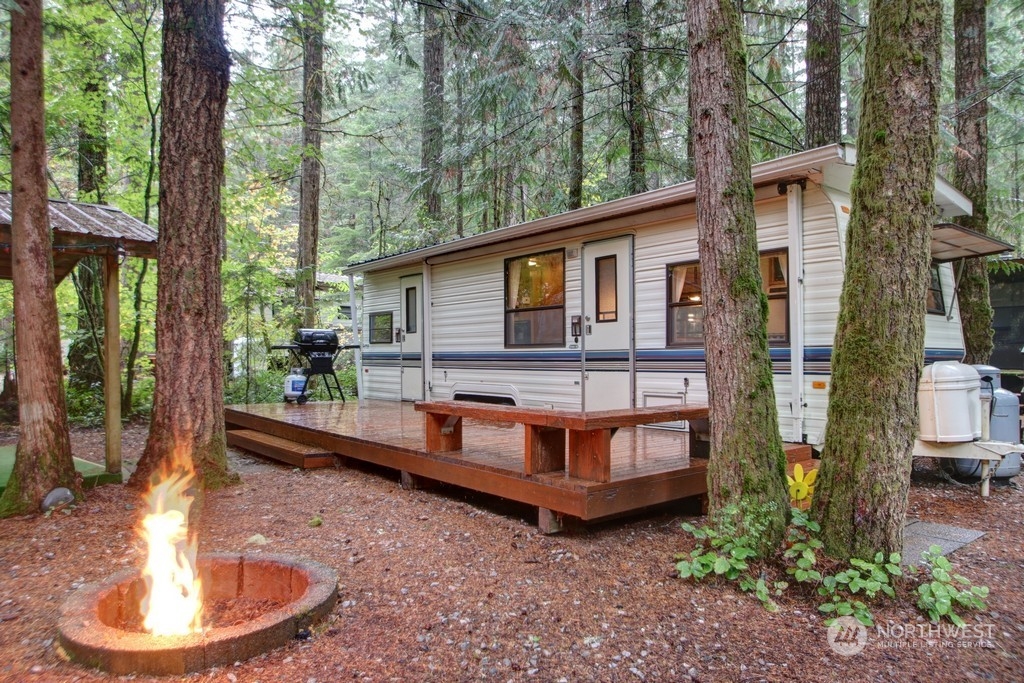 90-2 Wilderness Way Maple Falls, WA 98266 - Photo 1 of 39 a view of a house with backyard sitting area and swimming pool