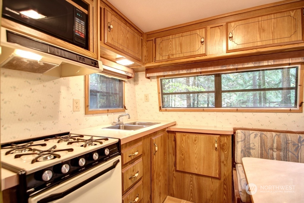90-2 Wilderness Way Maple Falls, WA 98266 - Photo 17 of 39 a kitchen with a stove a sink and a window