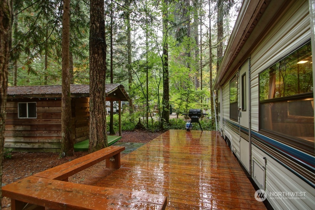 90-2 Wilderness Way Maple Falls, WA 98266 - Photo 2 of 39 a view of a balcony with chairs and wooden floor